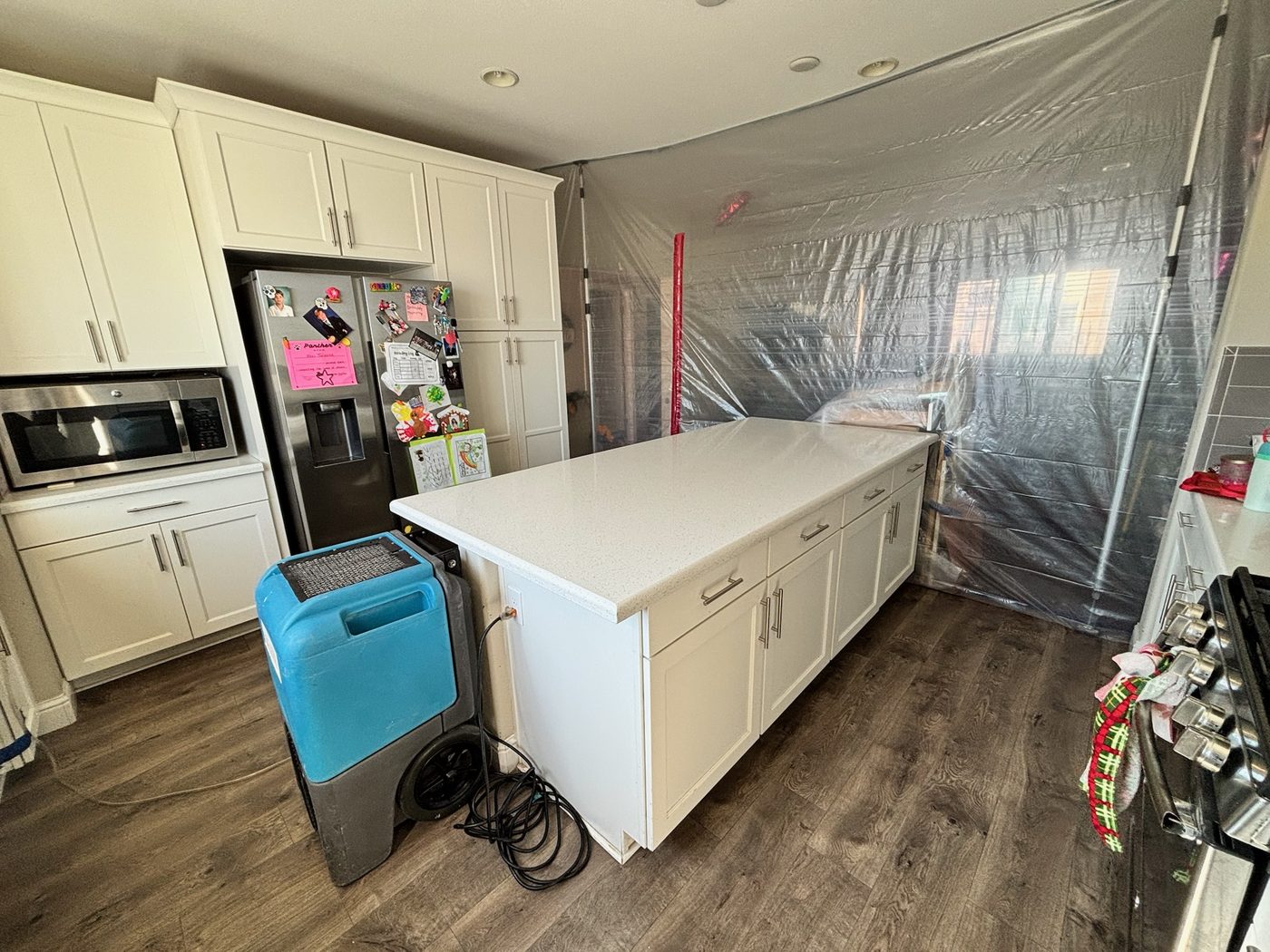 Air movers drying a bedroom after water damage