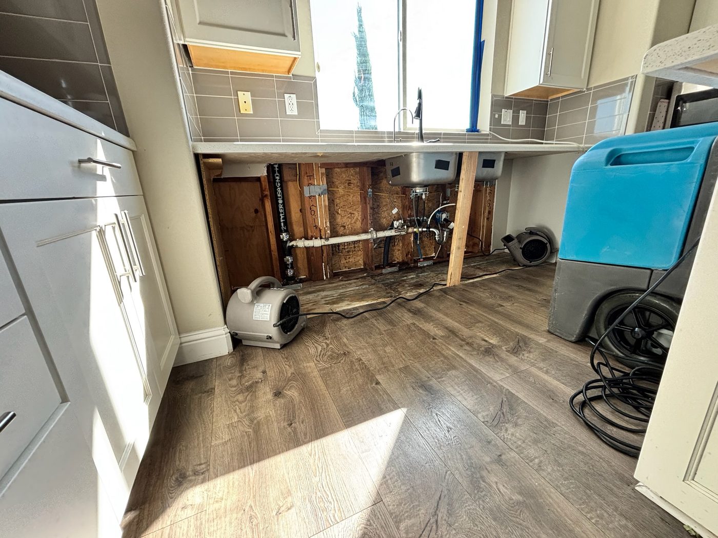 Standing water on a hardwood kitchen floor